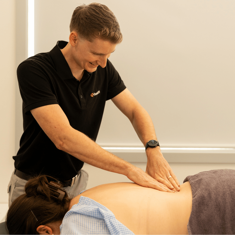 Osteopath providing physical treatment through back massage